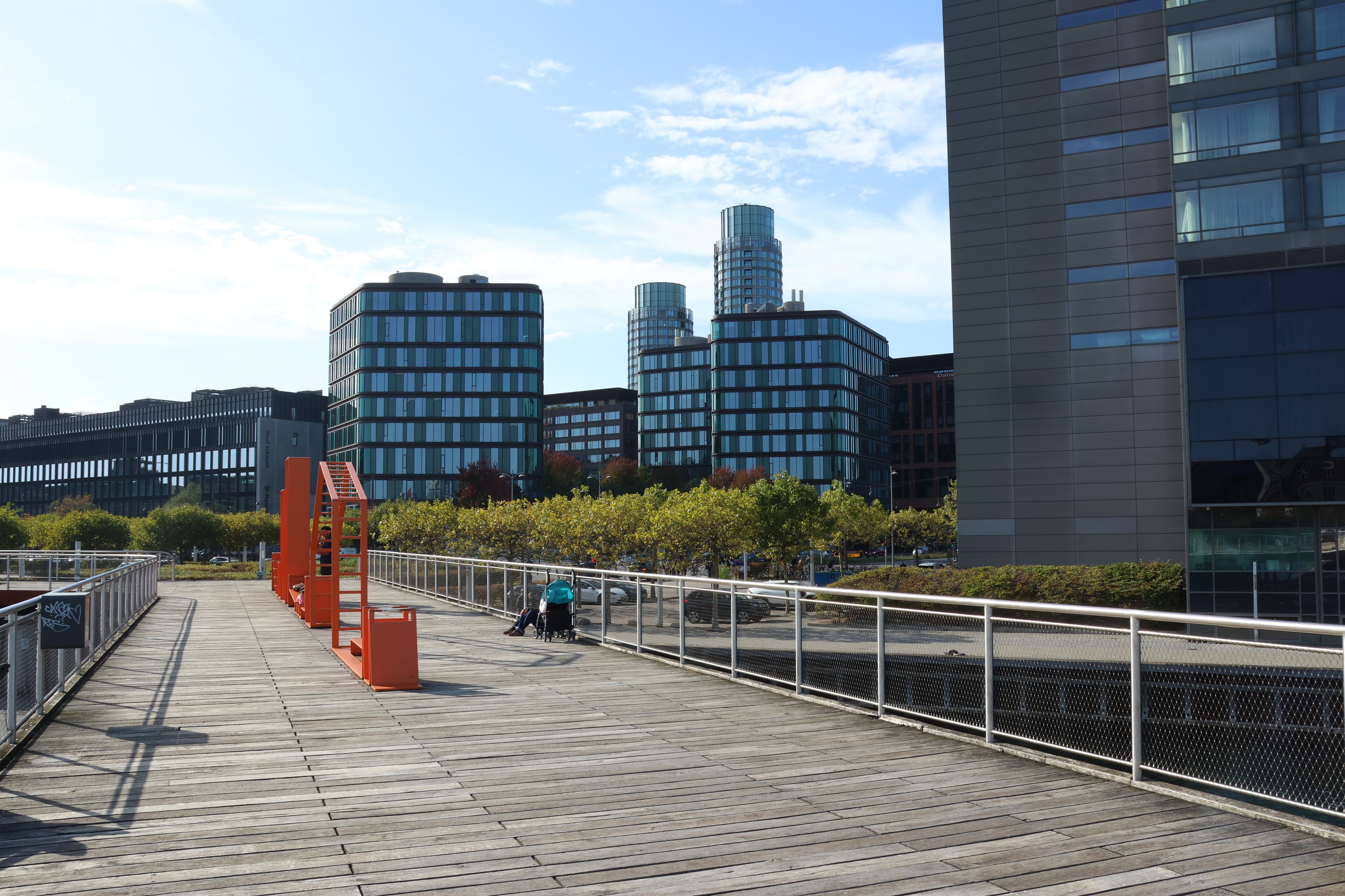 An orange steel stair on the boardwalk at Kalvebod Brygge