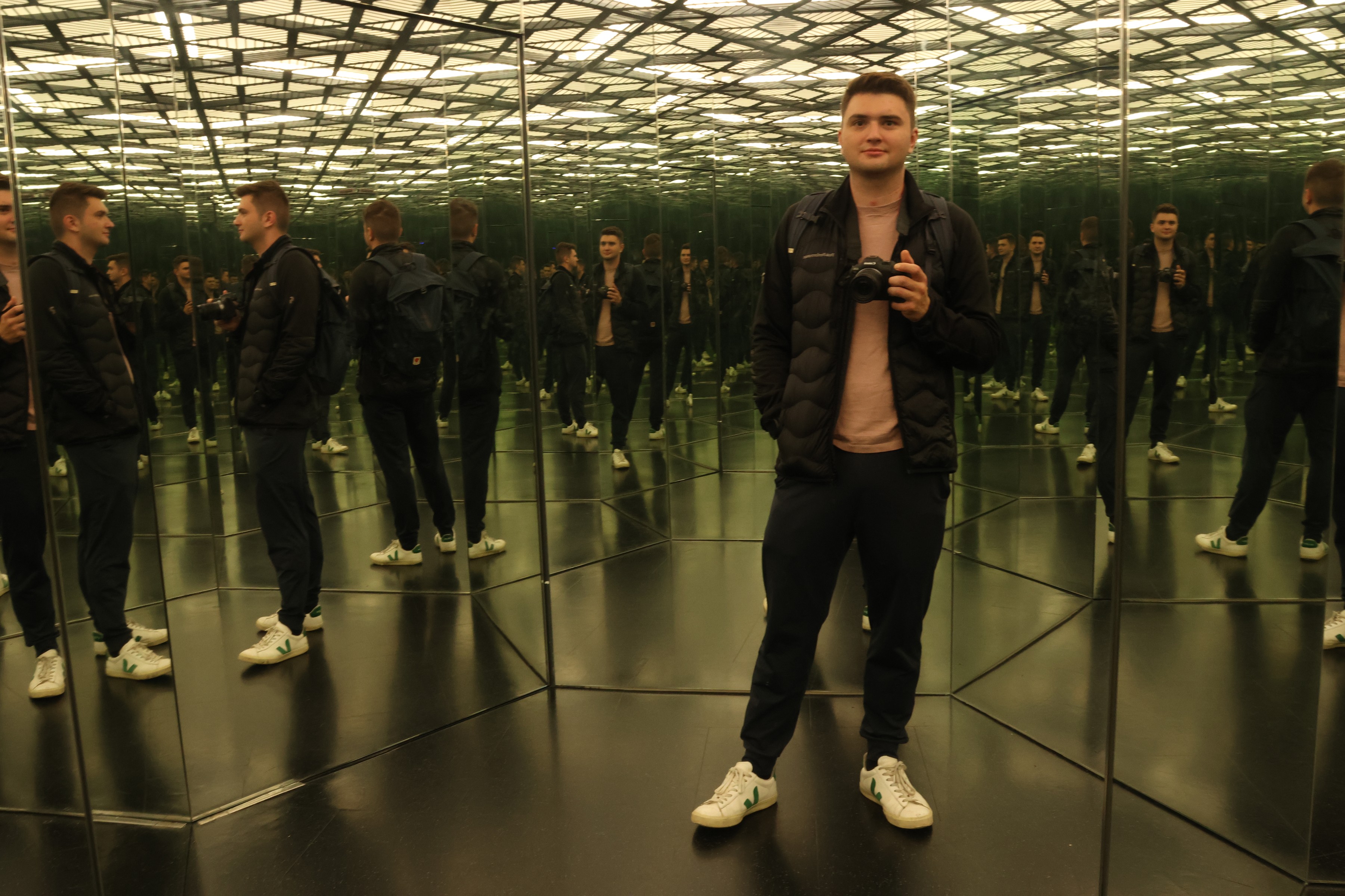 Endless reflections of a single figure in a mirrored room